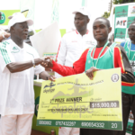 Edo Governor Adams Oshiomhole presents a cheque to Timothy Toroitich from Uganda, 2nd prize winner with time of 29 mins, 44 seconds at the Okpekpe Road Race 10km.